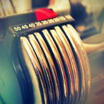 Close-up of adjustable dumbbells with bright lighting, perfect for fitness enthusiasts.