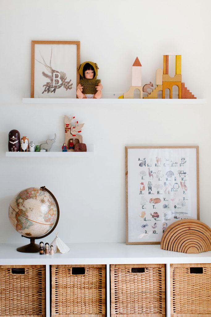 Floating wall shelves in a small apartment displaying plants, books, and decorative items to keep counters clear.